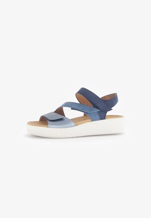 Two-tone blue sandals with a smooth upper, adjustable cross straps, a cushioned footbed, and a textured white sole.