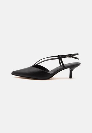 Décolleté in pelle nera con punta affilata, tacco kitten con sottile cinturino alla caviglia e fibbia, design slingback, su sfondo chiaro uniforme.