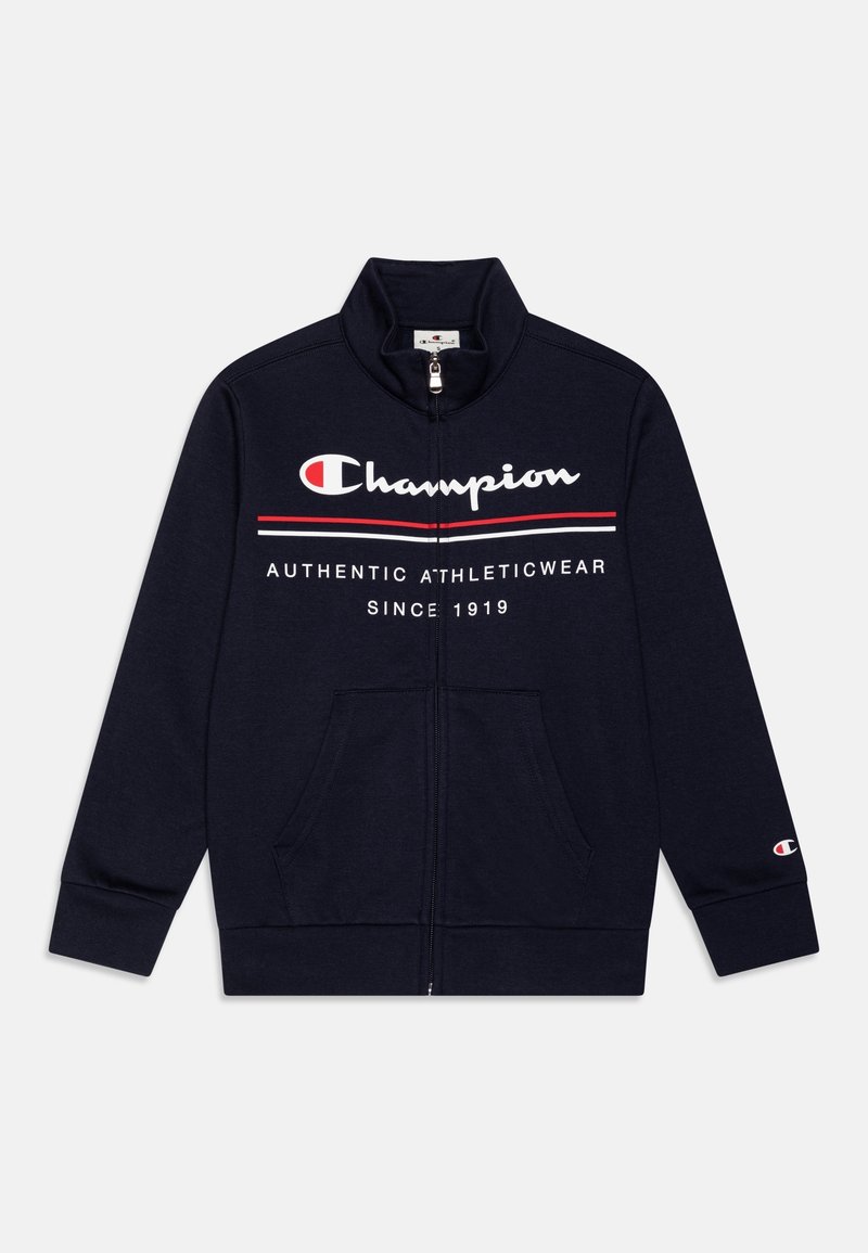 Sweat-shirt zippé bleu marine avec logo Champion, rayures rouges et blanches, poches avant et texte « Authentic Athleticwear Since 1919 » sur la poitrine.