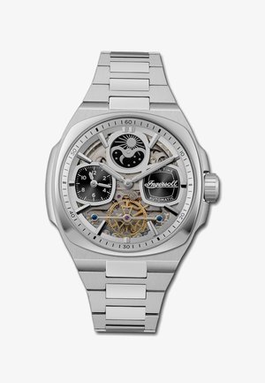 Orologio automatico in acciaio inossidabile con design a scheletro, quadrante nero con riflessi, lancette d'argento e dettagli blu e oro sul movimento.