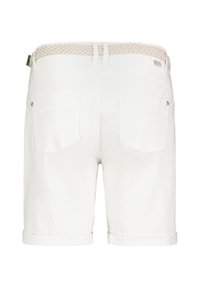 White cotton shorts featuring a braided fabric belt, rolled cuffs, and two back pockets with snap closures. Smooth texture and tailored fit.