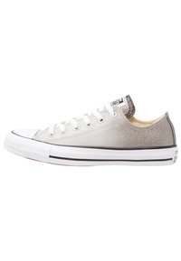 Silver glitter sneakers with white rubber sole, rounded toe, and classic lace-up design. Includes black and white striped accents on the heel.