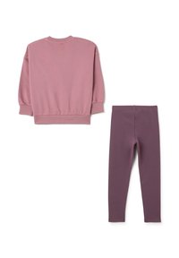 Sudadera rosa con puños y dobladillo acanalados, combinada con leggings morados. Ambos fabricados en tela suave; no hay patrones ni acentos notables visibles.