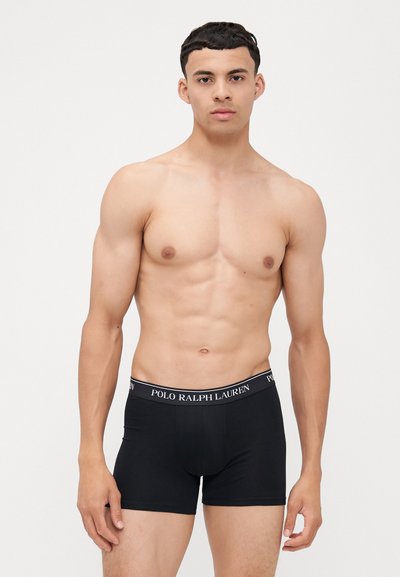 Boxeri negri cu o croială ajustată, având un brâu contrastant cu logo-ul "POLO RALPH LAUREN". Material neted și elastic.