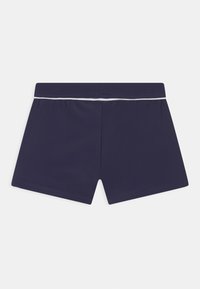 Navy swim shorts made of stretchy fabric, featuring a white elastic waistband and a simple, functional design with clean edges.