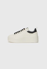 Sneaker platform bianche con accenti neri, caratterizzate da pelle testurizzata, punta rotonda e lacci in tessuto. Suola liscia con dettaglio del marchio.
