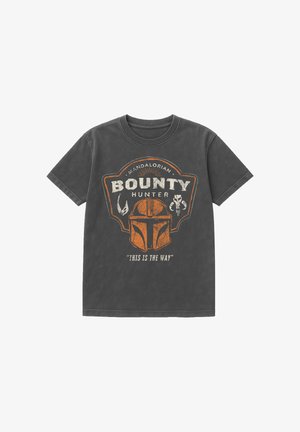 Dark gray t-shirt featuring an orange Mandalorian helmet, the words "Bounty Hunter" and "This is the way" in white.