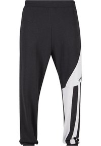 Schwarze Sweatpants mit weißem Seitenteil, das vertikale schwarze Streifen zeigt. Hergestellt aus weichem Stoff, mit elastischem Bund und geripptem Saum.