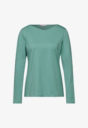 Pitkähihaisen t-paidan pehmeä mintunvihreä kangas, jossa on V-kaula-aukko ja yksinkertainen siluetti, sileä tekstuuri eikä koristeluja.