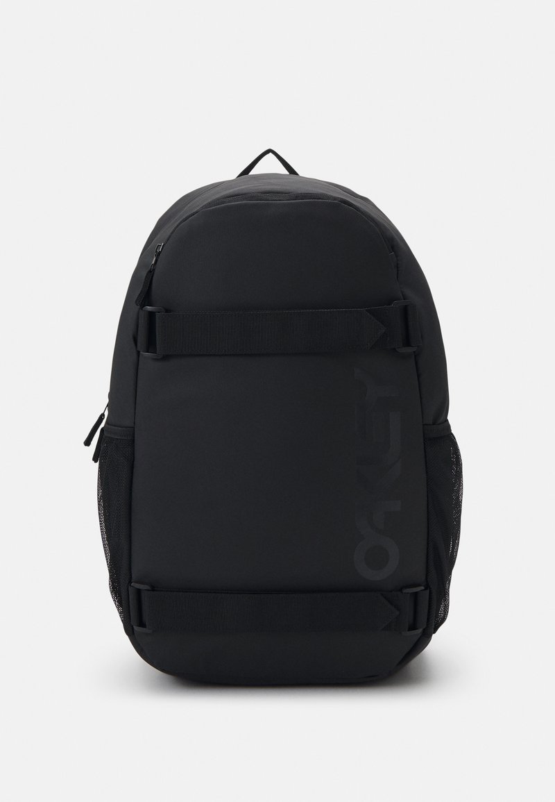 Black backpack with a smooth fabric finish, featuring a large main compartment, side mesh pockets, and a prominent logo on the front.