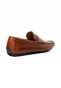 Brown leather moccasin slip-on shoe with a low profile, rounded toe, and rubber outsole. Features detailed stitching near the upper.
