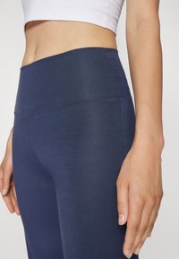 Yogasearcher JAIPUR FLARE PANTS - Tracksuit bottoms - navy