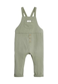 Salopette en coton vert clair avec des bretelles réglables, une poche avant et quatre boutons en bois le long de la poitrine. Jambes avec ourlets à la cheville.