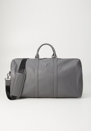 Grau Ledertasche mit zwei Griffen und verstellbarem schwarzen Schultergurt, ausgestattet mit einem kleinen dreieckigen Logo in der Mitte der Vorderseite.