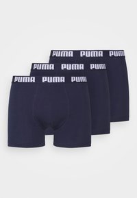Three pairs of navy blue boxer briefs with a white Puma logo on the elastic waistband. Made from soft, stretchy fabric.