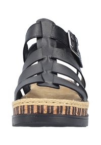 Sandale en cuir noir avec un design de tige tissé, boucle réglable en argent et semelle compensée en jute enveloppée avec un motif rayé.