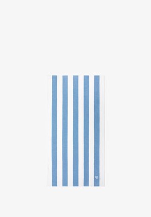 Striped cotton towel with alternating light blue and white stripes. Features a textured surface and a small logo in the lower corner.