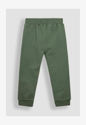 Roheline dressipüksid pehmest puuvillast, millel on elastne vöökoht ja mansetid, sujuva tekstuuri ning lihtsa disainiga.