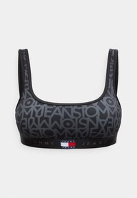 Μαύρο αθλητικό σουτιέν με γκρι επαναλαμβανόμενο εμπριμέ "Tommy Jeans" και ελαστική ταινία με το λογότυπο της σημαίας Tommy Hilfiger στο μπροστινό κέντρο.