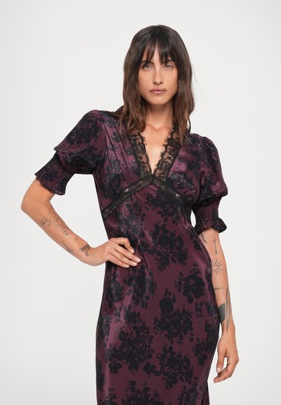 Satin dress in dark burgundy with black floral pattern, featuring a deep V-neck, lace trim, puff sleeves, and a fitted silhouette.