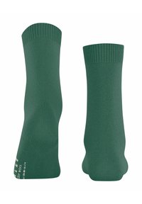 Pair of plain green woolen crew socks displayed upright with ribbed cuffs on a white background.