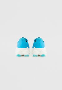 Blue athletic shoes with a textured mesh upper, white cushioned sole, and turquoise accents. Rounded heel with logo detail at the back.