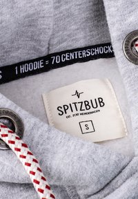 Gray hoodie with a textured surface, featuring a white and red braided drawstring, metal eyelets, and a fabric label with brand details.