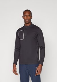 Schwarzes langärmeliges Oberteil aus glattem Stoff, mit einem halben Reißverschlusskragen und einer grauen Reißverschlusstasche auf der Brust. Sleek, modernes Design.