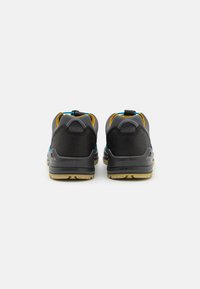 Scarpe da trekking nere e grigie con accenti blu e gialli. Presentano una tomaia in mesh testurizzato, un colletto imbottito e una suola in gomma per trazione.