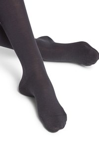 Collants pretos feitos de material liso e opaco, com um ajuste justo e costuras planas. Acabamento texturizado que adiciona um interesse visual subtil.