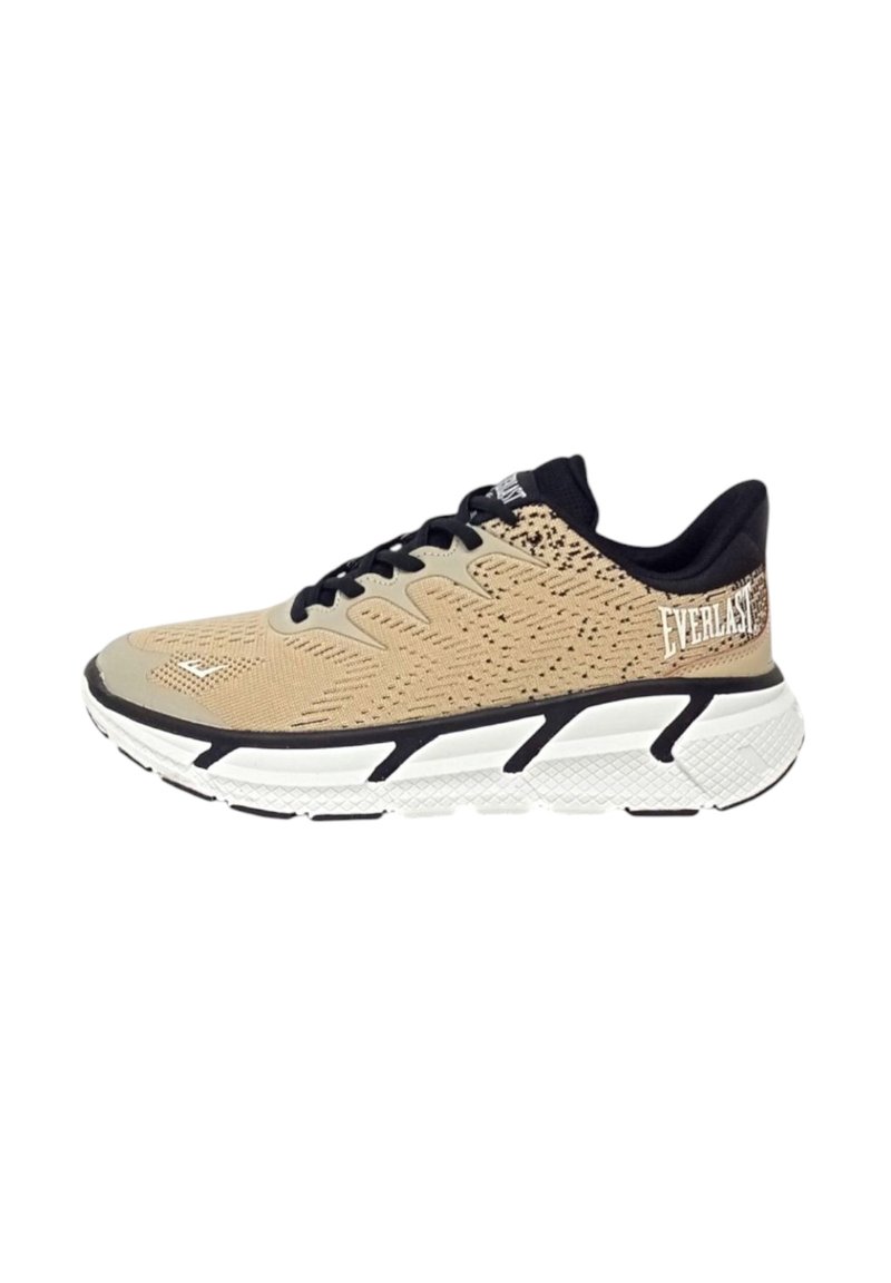 Scarpa atletica beige con tomaia in rete testurizzata, dettagli neri, lacci e una suola bianca e imbottita con un design a motivi. Logo sul tallone.