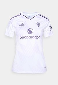 Bela nogometna majica z vijoličnimi detajli in črtami. Ima logotip Adidas, emblem leva in napis "Snapdragon" na sprednji strani. AeroReady tehnologija.