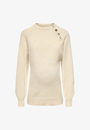 Krema barve pulover, izdelan iz mehkega pletenega materiala, s krožnim izrezom, dolgimi rokavi in dekorativnimi gumbi na levi rami.