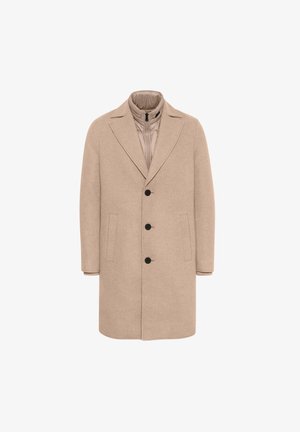 Beige gyapjúkabát, következő sarkantyúval, steppelt bélésű, öt gombbal és két oldalsó zsebbel. Simaszerkezetű, testhezálló fazon.