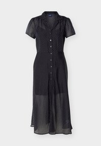 Μαύρο διάφανο μεσάτο φόρεμα με λευκά πουά, κοντά φουσκωτά μανίκια, κουμπιά μπροστά και γιακά.