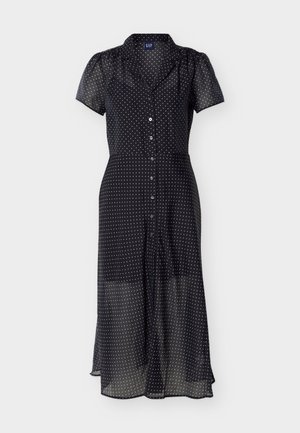 Juoda permatoma midi suknelė su baltais taškeliais, trumpomis pūstomis rankovėmis, sagomis priekyje ir apykakle.