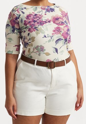 Floral-patterned top in cream with purple, pink, and green flowers; paired with white shorts and a brown belt with a gold buckle.