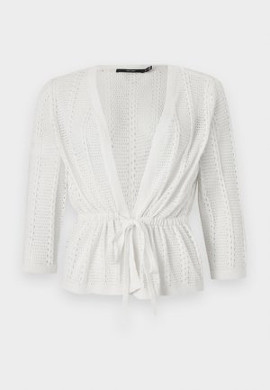 White knitted cardigan with open front, long sleeves, textured pattern, and a tied waist belt.