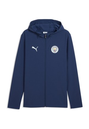 Marineblaue Kapuzenjacke mit durchgehendem Reißverschluss und subtilem Muster, Puma-Logo auf der rechten Brust und Manchester City Emblem auf der linken Brust.