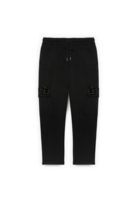Pantaloni jogging neri realizzati in morbido materiale, con due tasche frontali decorate con accenti di perline nere. Vita elastica con cordino.