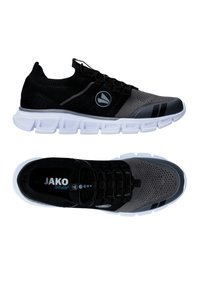 Scarpe sportive nere e grigie con tomaia in maglia, design geometrico, suola bianca e logo JAKO sulla soletta.