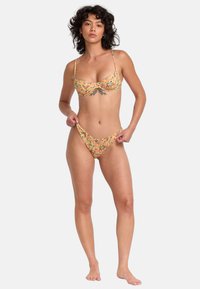 Floral bikini set featuring a yellow background with colorful patterns. The top has a soft underwire and adjustable straps, while the bottom is a low-rise style.