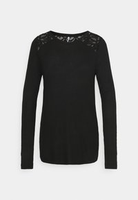 Svart långärmad skjorta med spetsdetaljer på axlarna och halsringningen, med rund hals och figurnära silhuett.