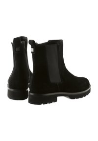 Bottines en suede noir avec des panneaux latéraux élastiques, bout arrondi, semelle texturée et talon renforcé, arborant un logo discret à l'arrière.