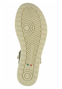 White rubber shoe sole with zigzag tread pattern, embossed branding, and circular design elements. Features Italian flag color accents.