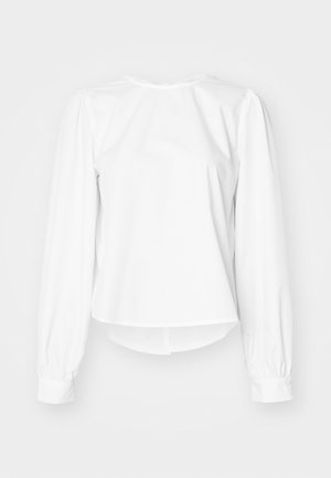 Bela bluza z dolgimi rokavi in ohlapnim krojem, z napihnjenimi rokavi, zaobljenim izrezom in gumbnimi manšetami. Gladka, sveža tekstura.