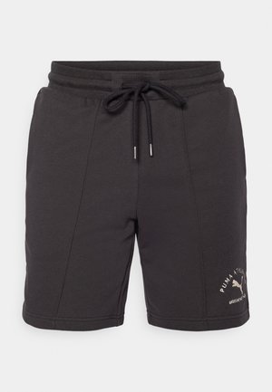 Sorte sportshorts lavet af blødt stof med elastisk talje, snørebåndslukning og broderet logo-detalje på siden.