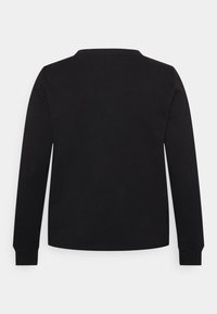 Camisa preta de manga longa feita de algodão suave, com decote redondo e punhos ajustados. Simples, de cor sólida sem padrões ou detalhes.