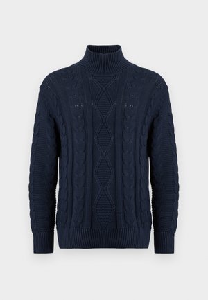 Marineblå polokragegenser laget av teksturert strikket stoff, med kabelmønstre og ribbede mansjetter ved håndleddene og kanten.