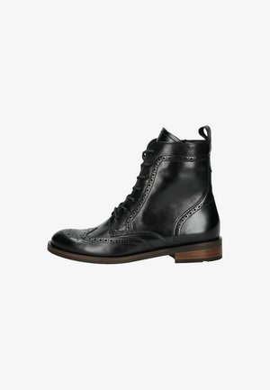 Black leather ankle boots with brogue detailing, lace-up front, rounded toe, flat heel, and a brown wooden sole accent.
